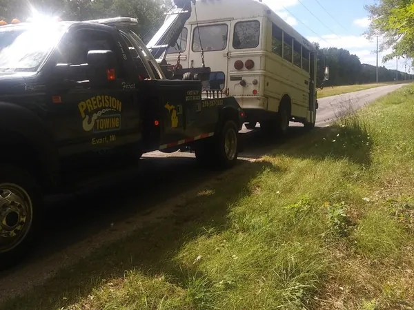Tow truck hooked to a camper on the roadside