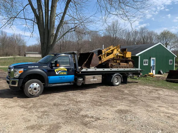 Equipment loaded on a Precision Towing flatbed