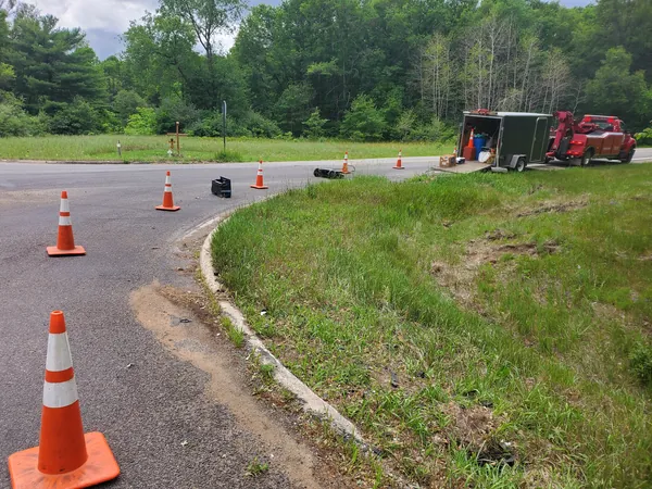 Cones and spill-response trailer at a roadside cleanup