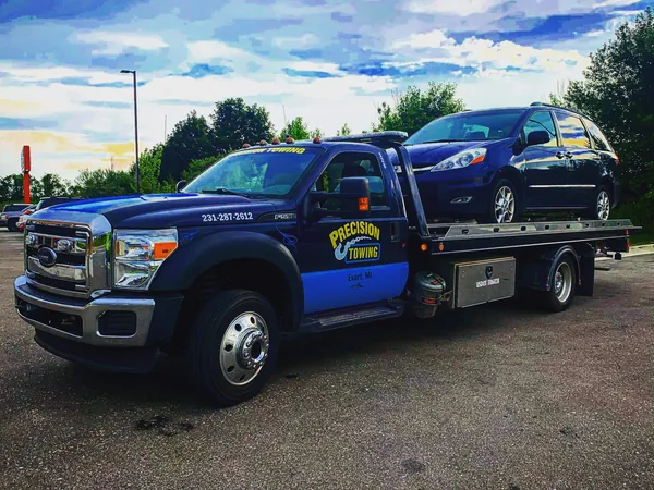 Precision Towing flatbed hauling a car near Evart, MI