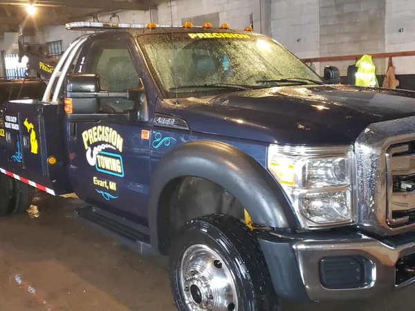 Precision Towing wrecker inside the shop