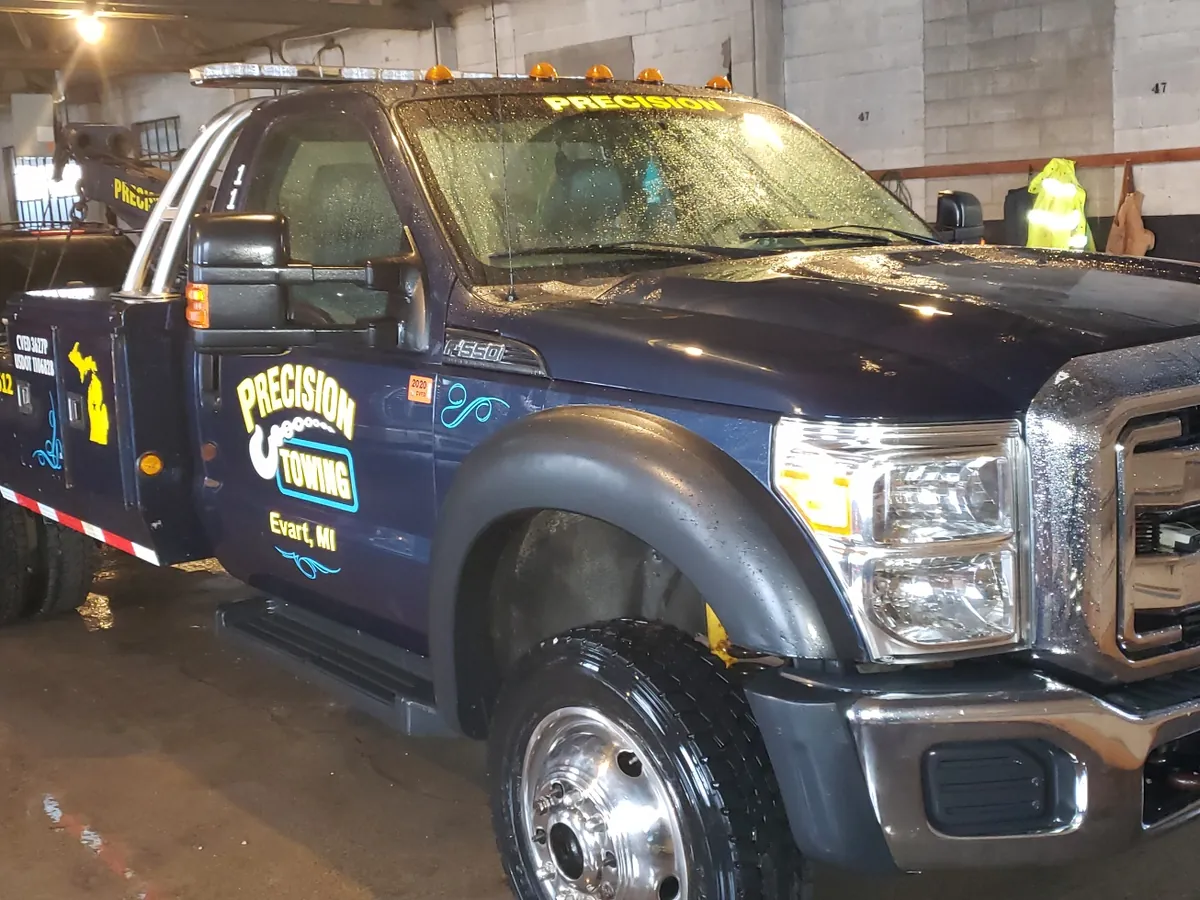 Precision Towing wrecker inside the Evart shop