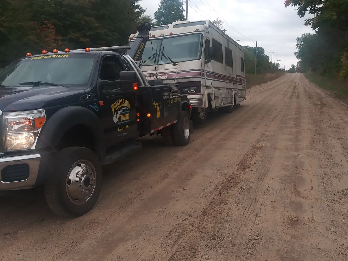 Precision Towing wrecker towing a motorhome